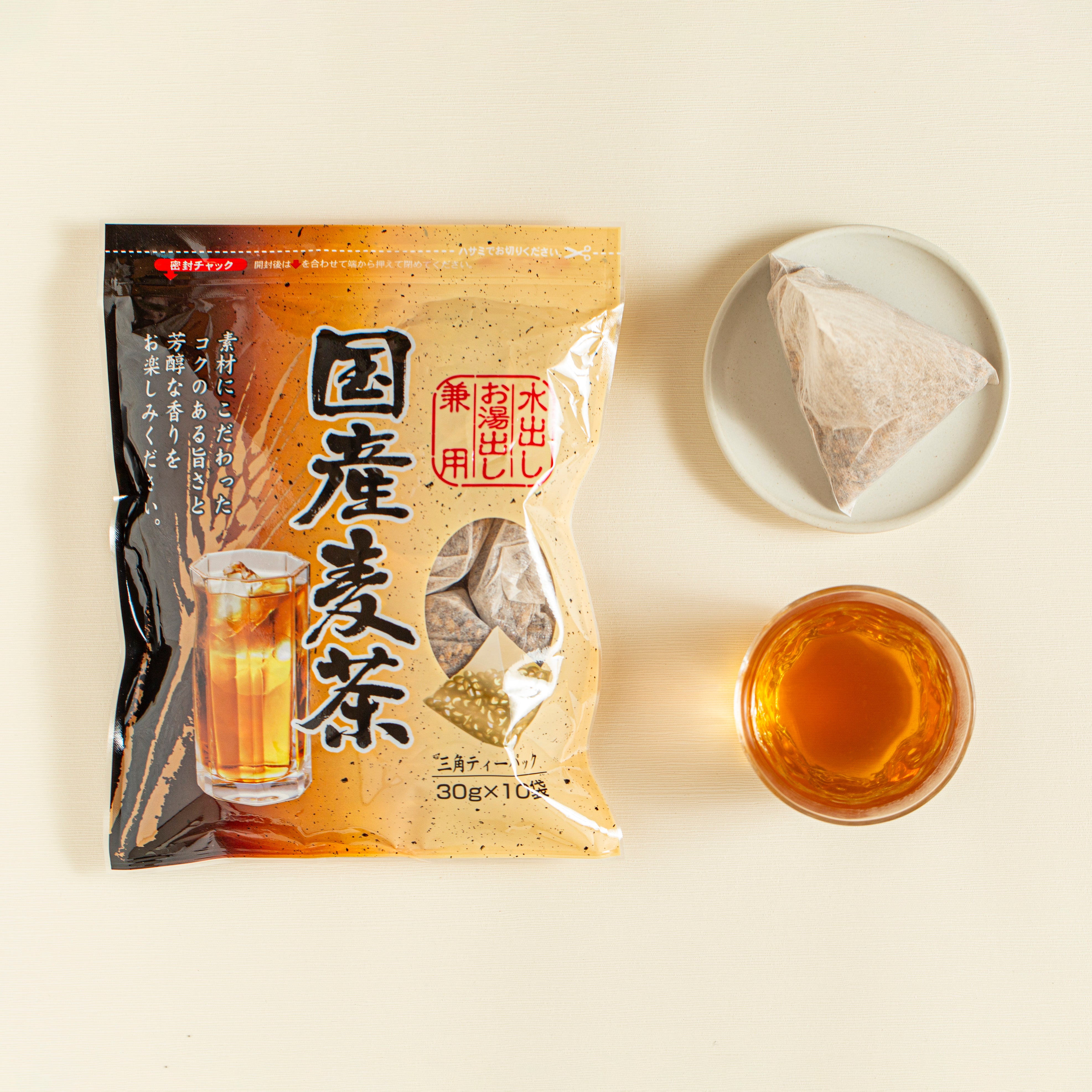 Tea package with a glass of tea on a light background