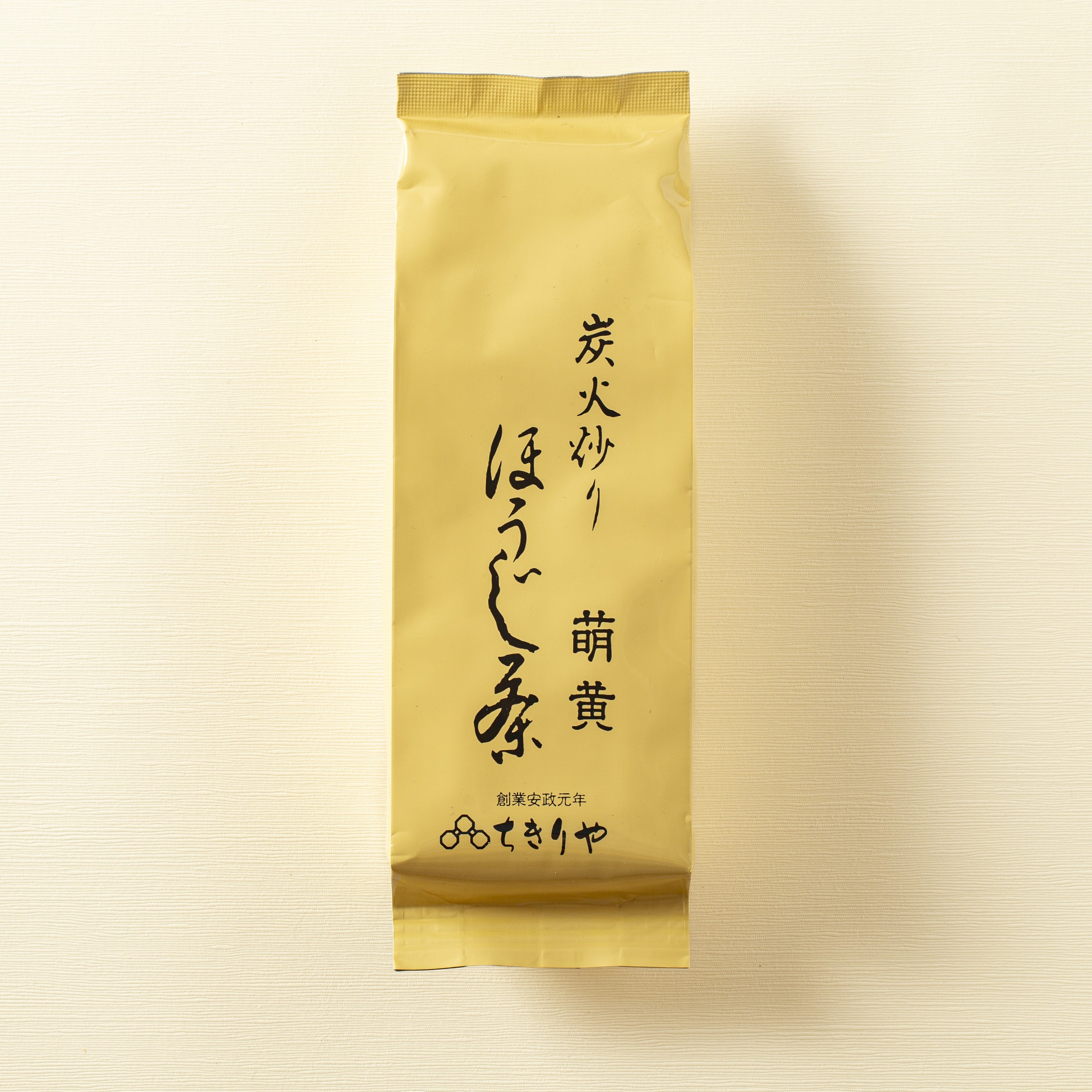 Gold package with black text on a beige background