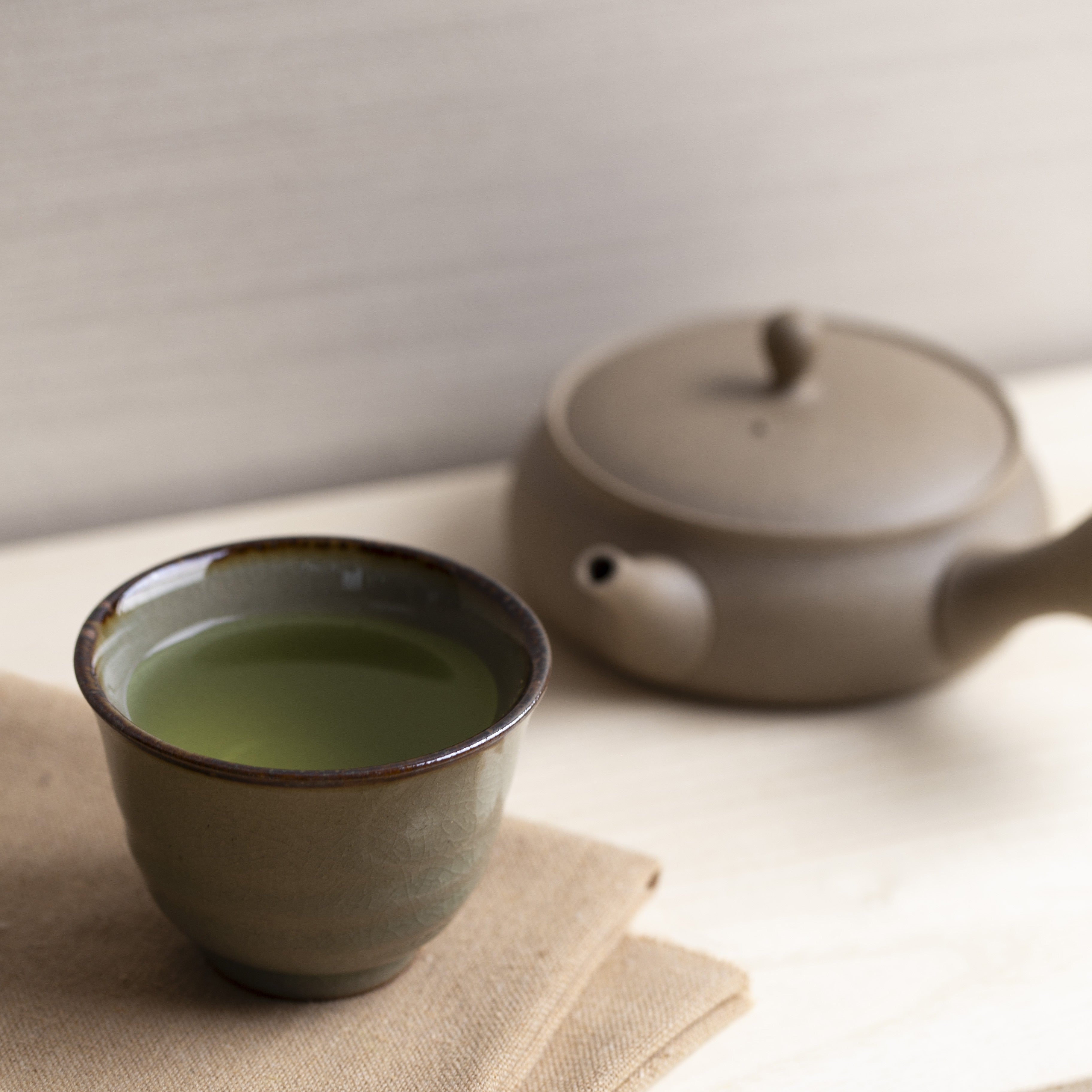 Green tea in a cup and teapot