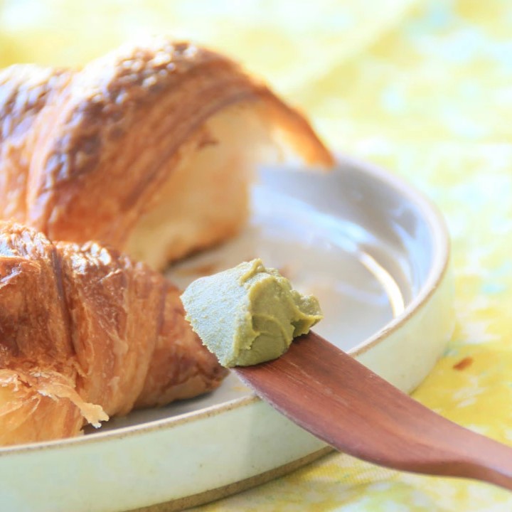 Matcha Jam on wooden spoon and croissant