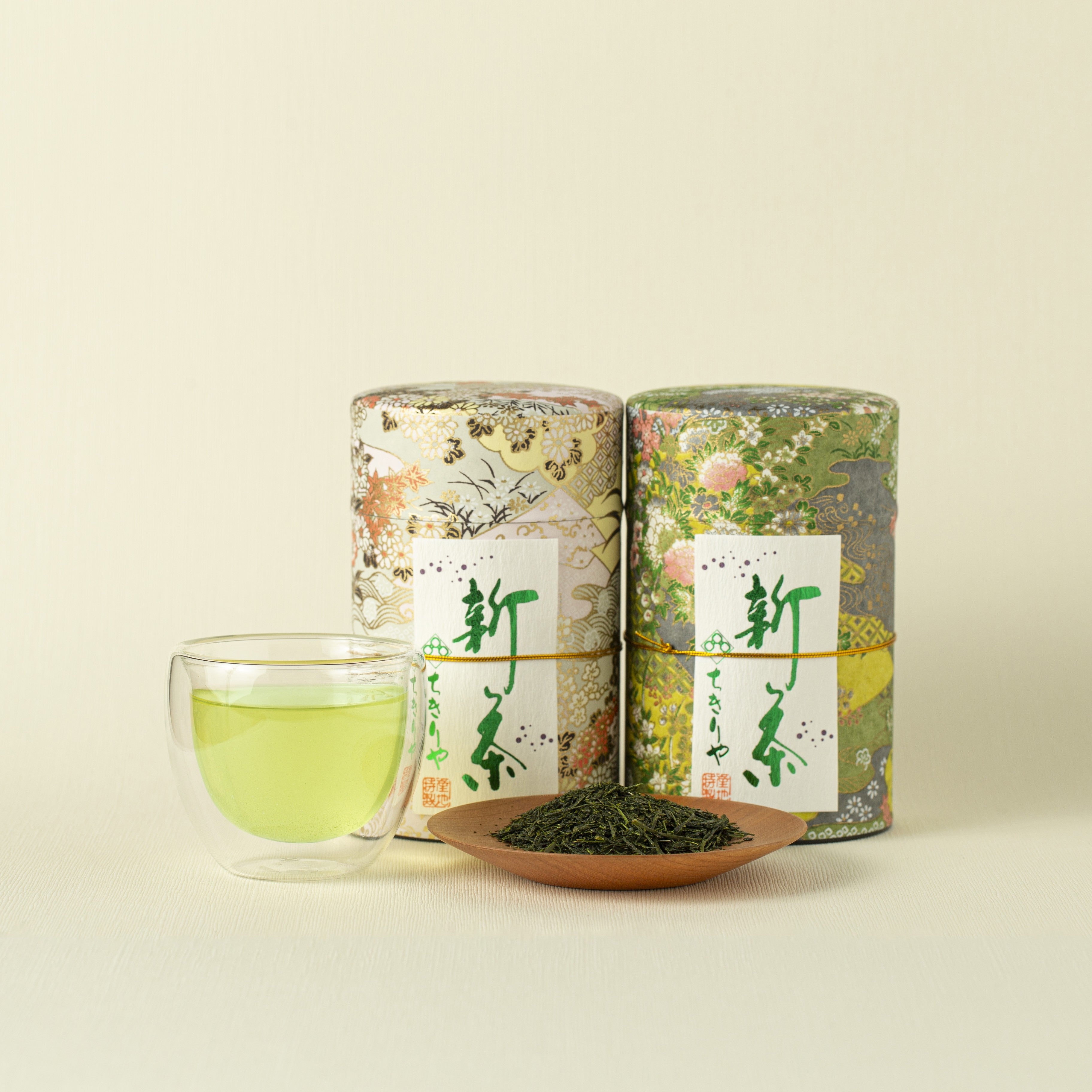 Shincha Shizuoka Premium cans and tea leaves and tea in a glass cup