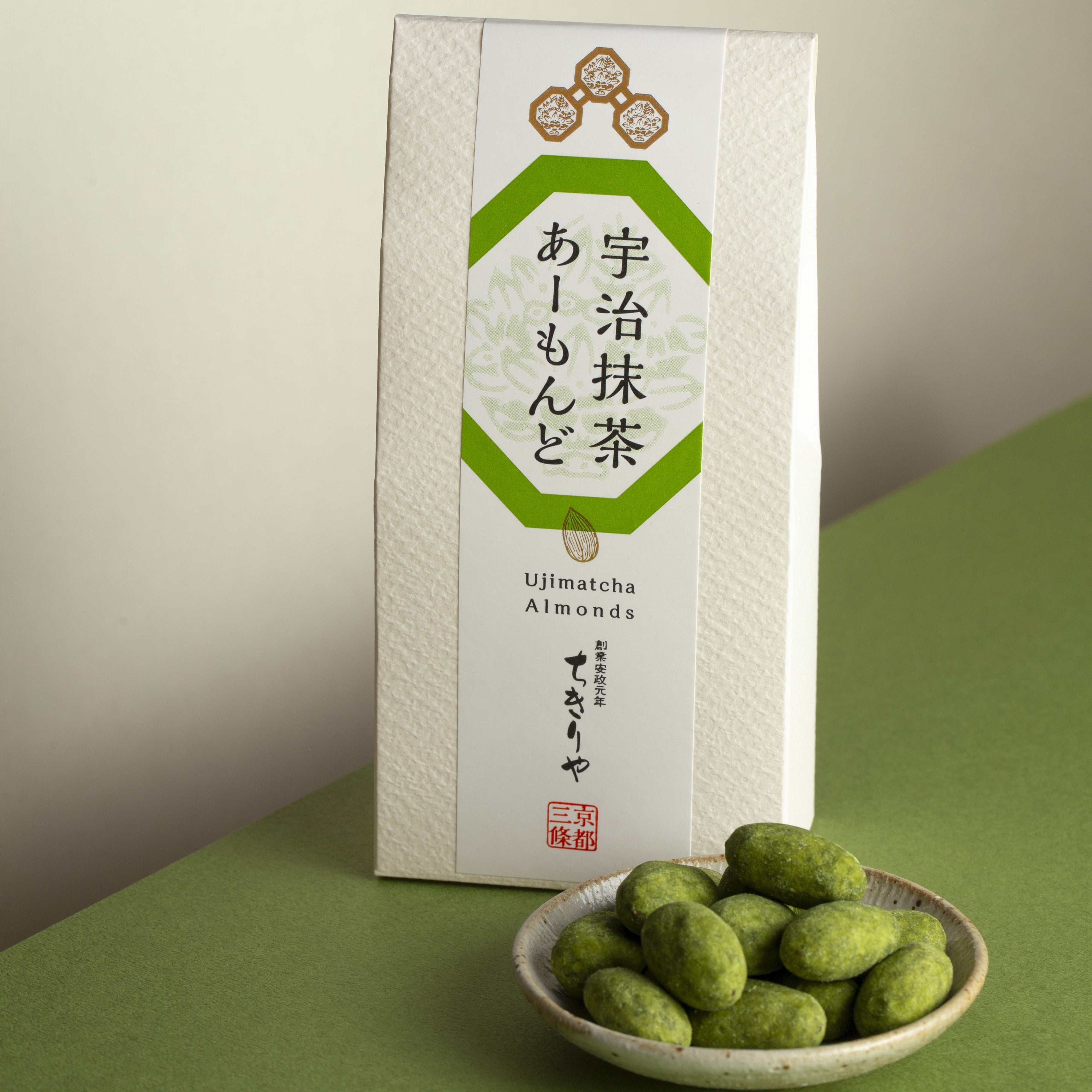 Uji Kyoto Matcha Coated Almonds box with the crunchy hojicha almonds in a plate