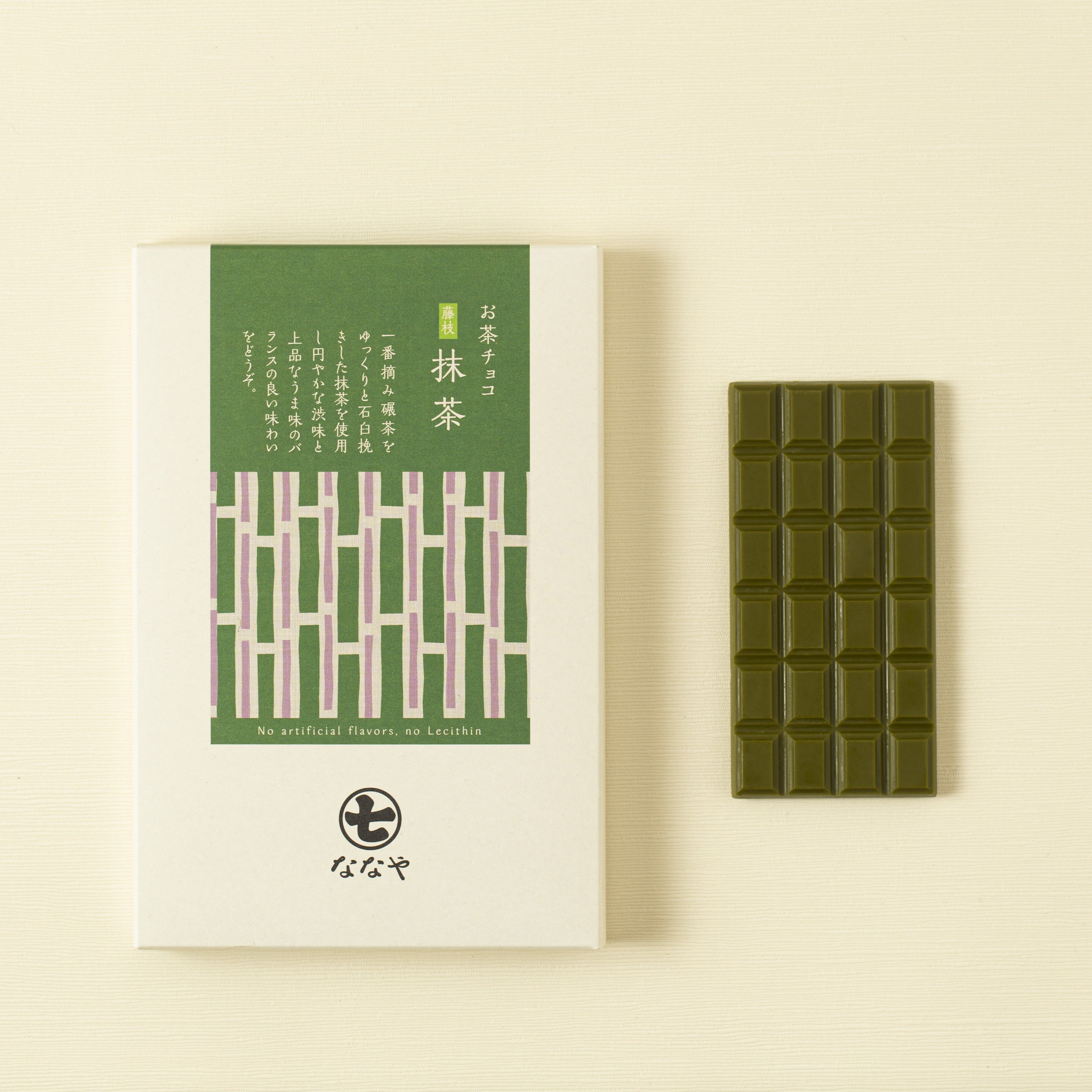 Green tea matcha chocolate bar with packaging on a beige background