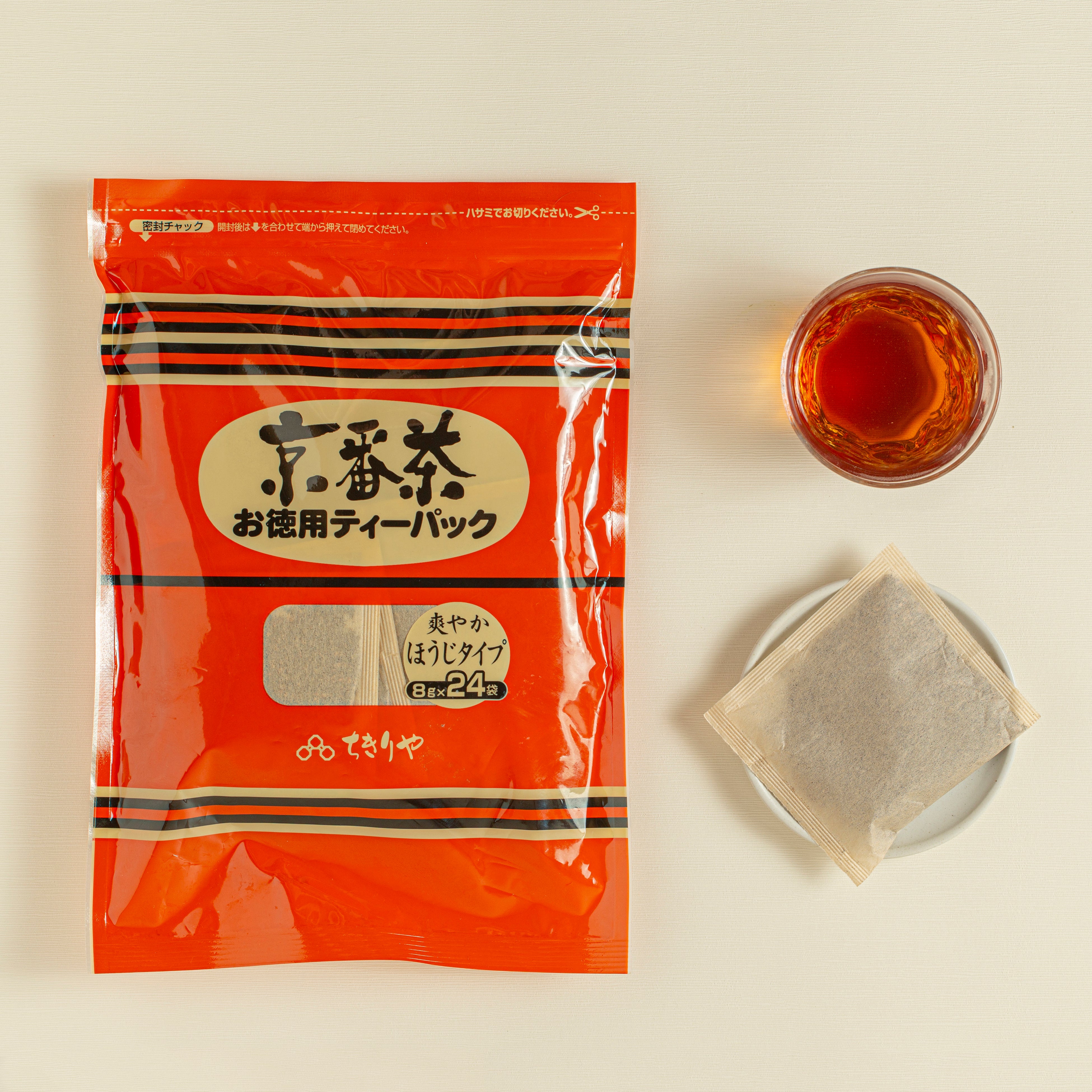 Tea package with a cup of tea and a tea bag on a light background
