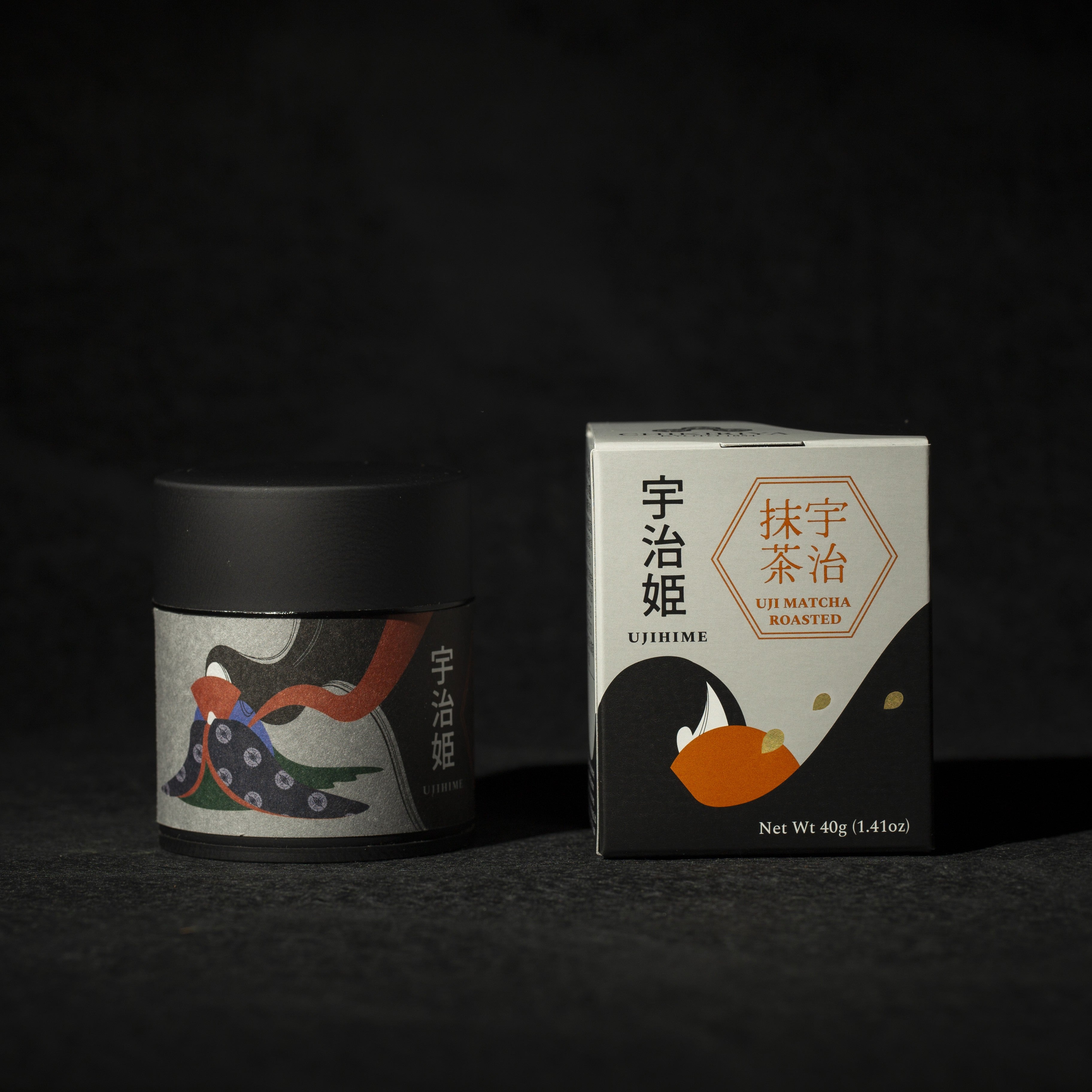 Tea canister and box with decorative designs on a dark background