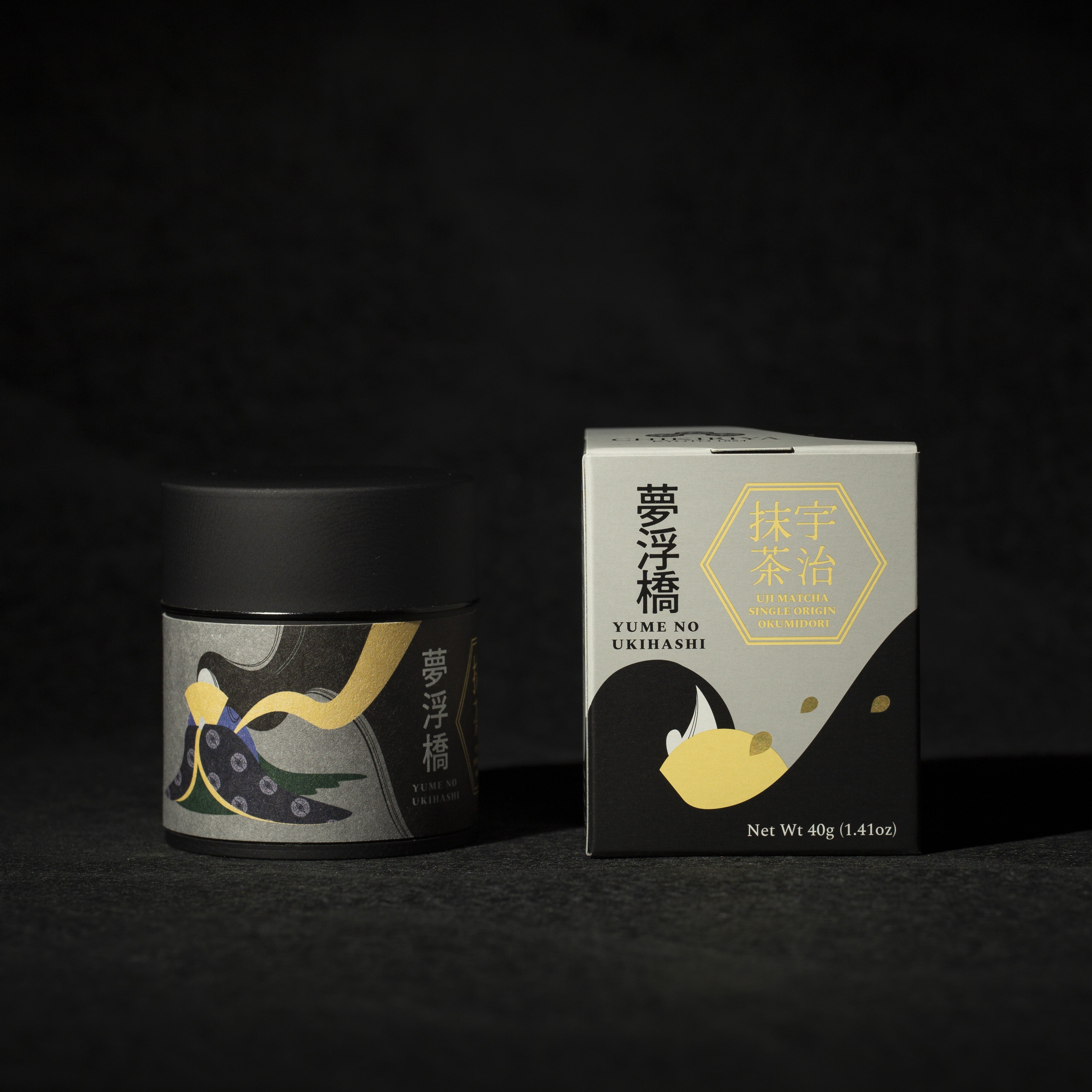 Tea canister and box with artistic design on a dark background