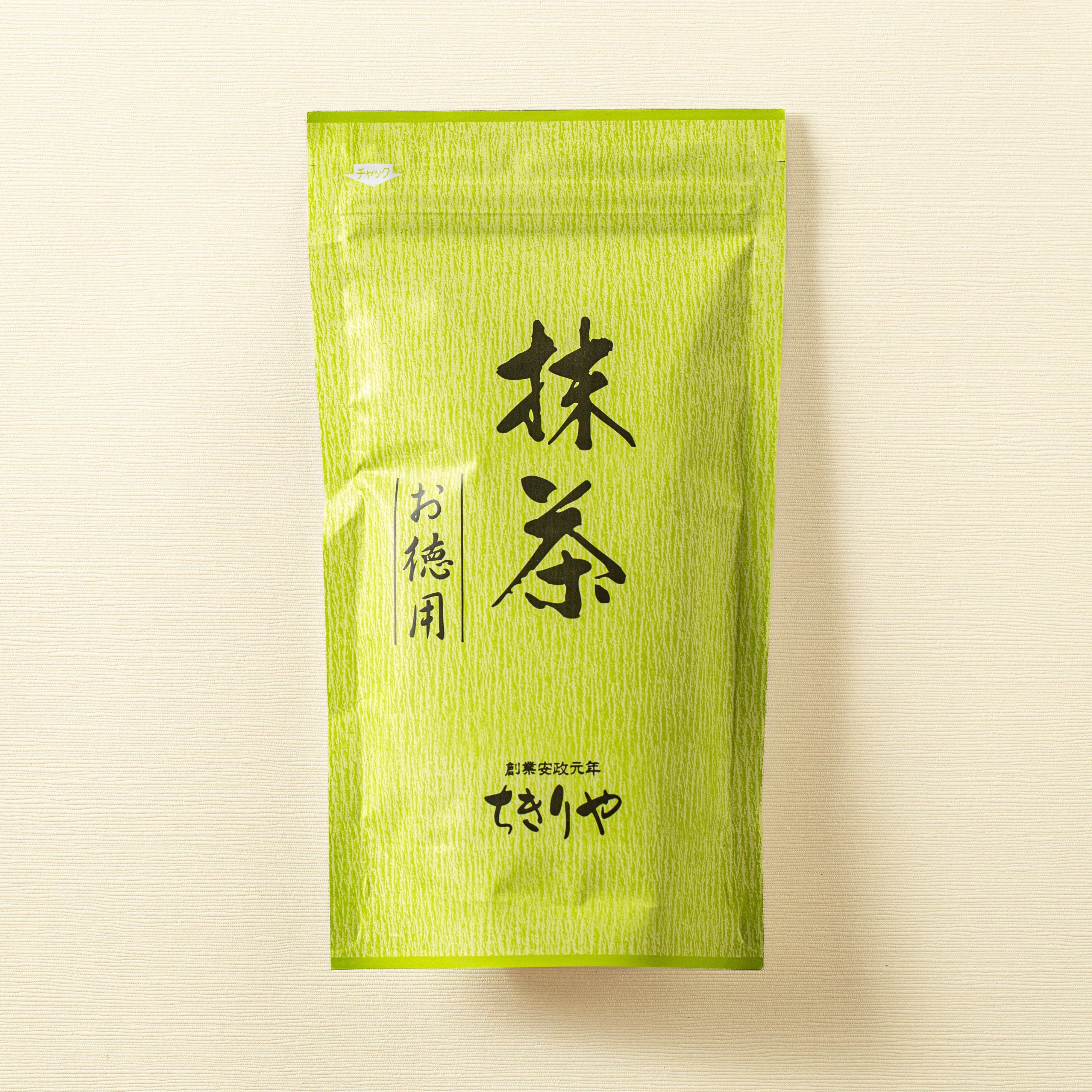 Green tea package with Japanese text on a beige background